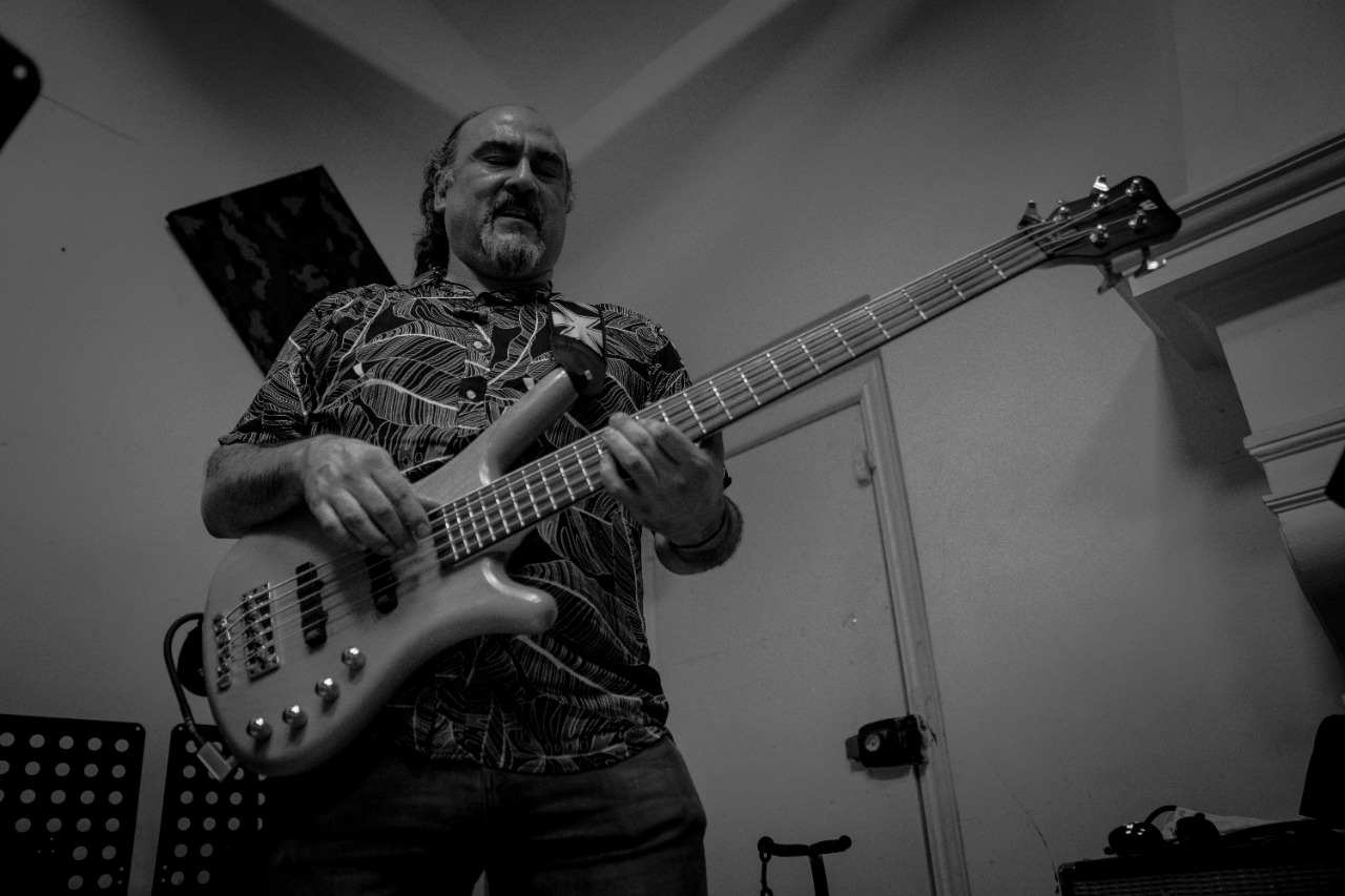 Black and white profile portrait of a musician in soft light